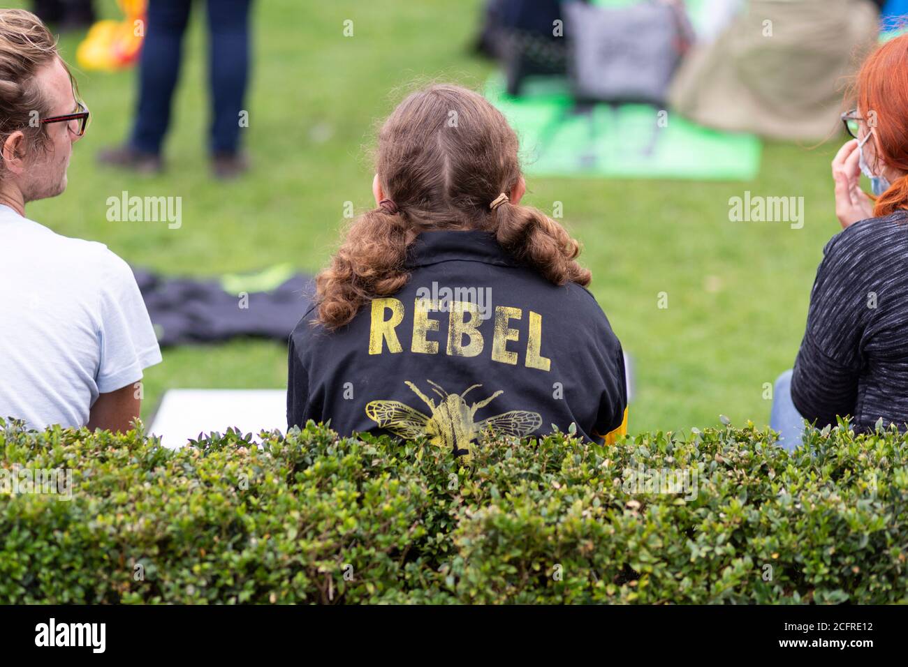 Text on a protester's jacket reading 'Rebel' at Extinction Rebellion demonstration, Parliament Square, London, 3 September 2020 Stock Photo