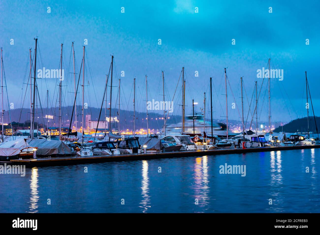 Harbour with yachts in downtown of Oslo at Oslofjord sea waterfront. Evening seascape. Stock Photo