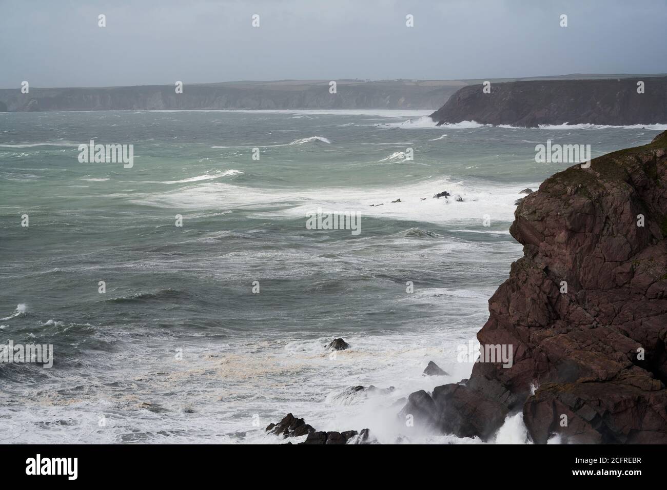 Storm pounding the cliffs near St. Ann's Head, entrance to Milford Haven, Pembrokeshire, Wales Stock Photo