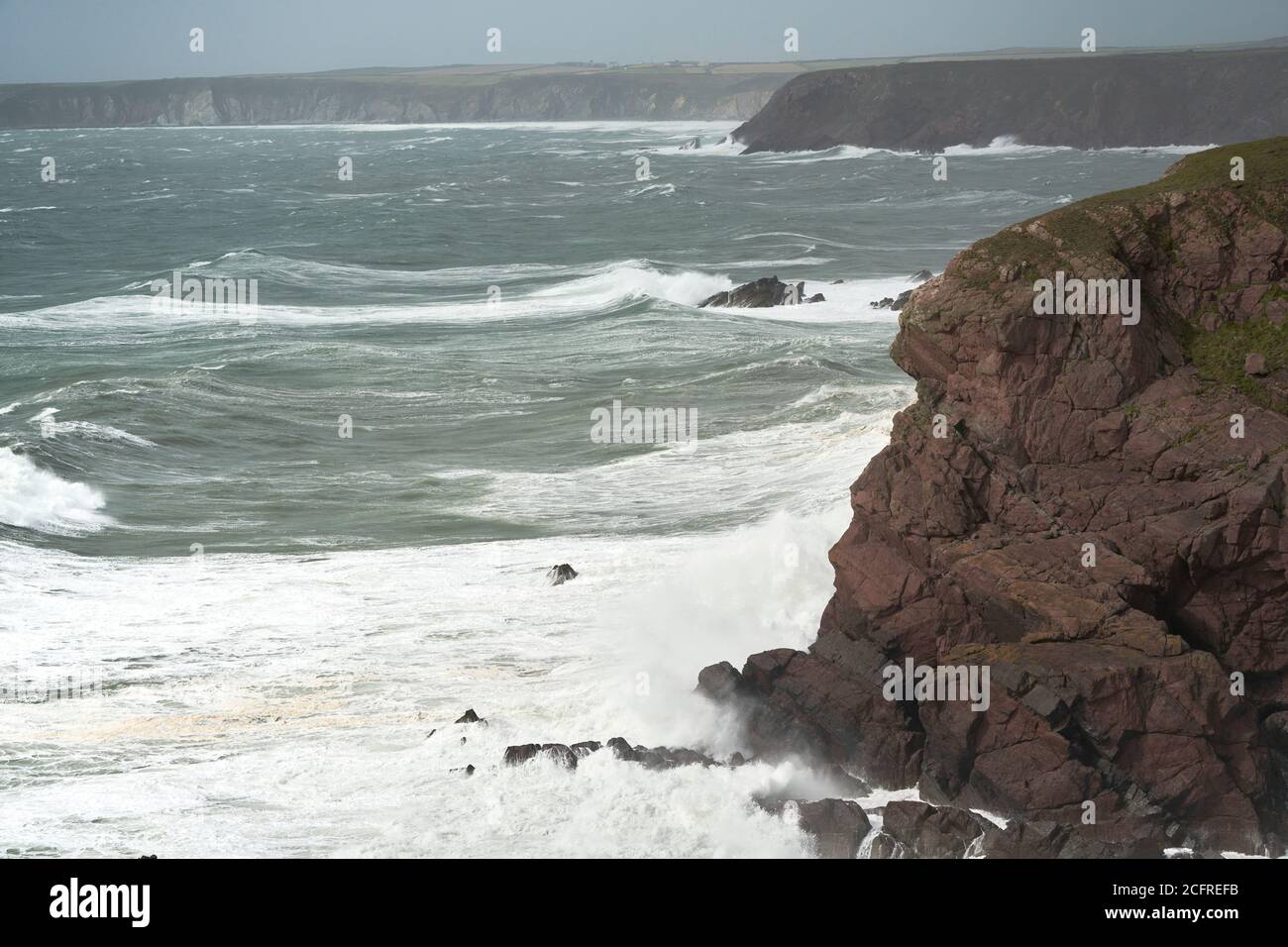 Storm pounding the cliffs near St. Ann's Head, entrance to Milford Haven, Pembrokeshire, Wales Stock Photo