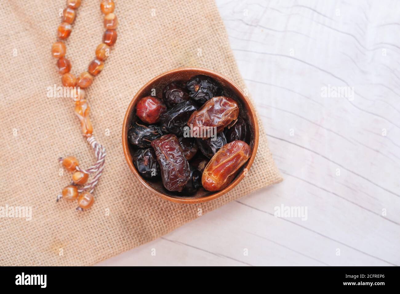 the concept of ramadan, fresh date fruit in a bowl on table  Stock Photo