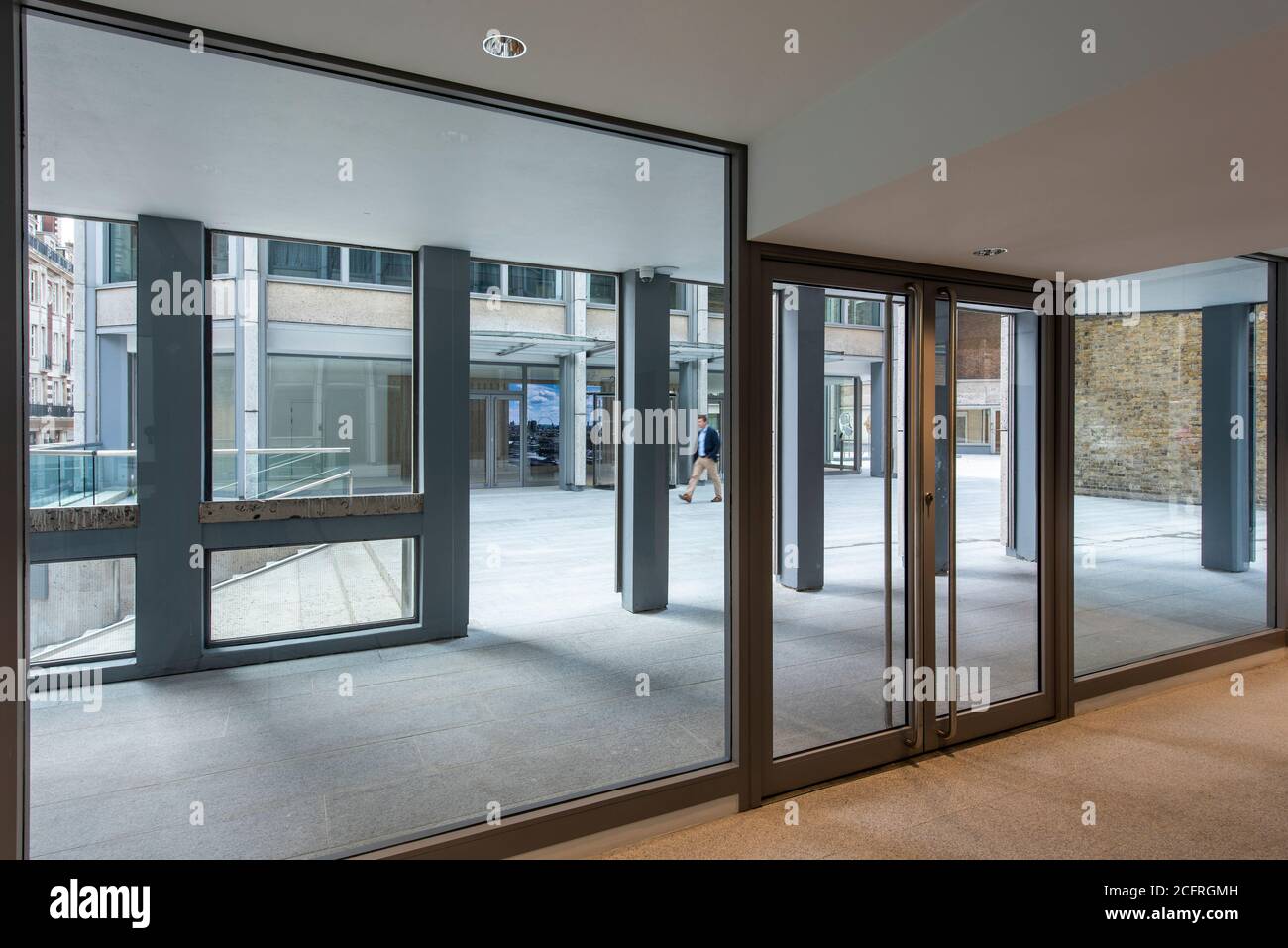 View through reception lobby of residential tower to plaza. The Economist Building, London, United Kingdom. Architect: Alison & Peter Smithson, dsdha Stock Photo