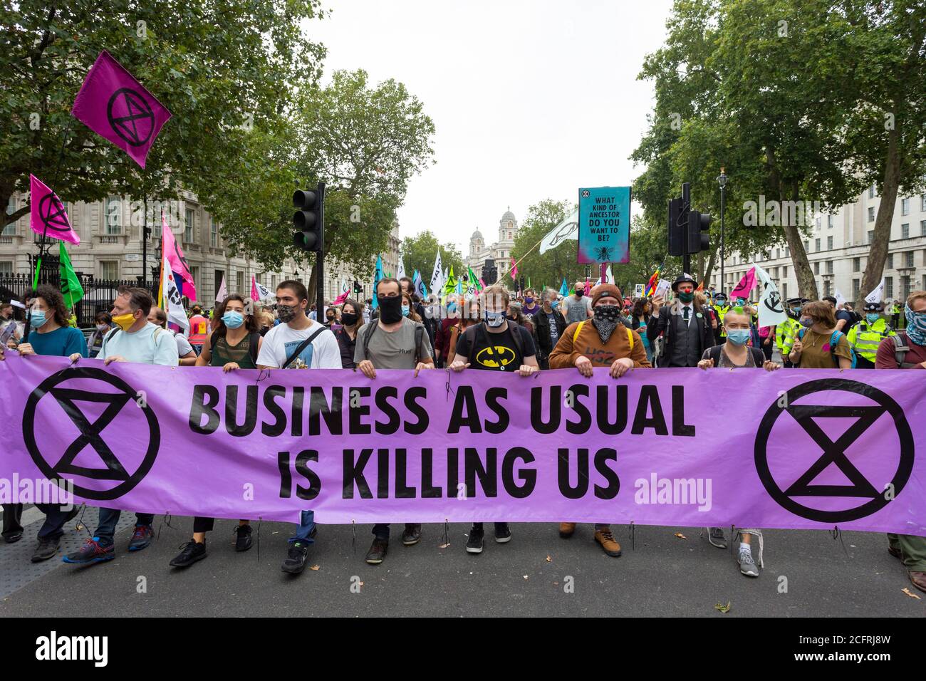 Protesters marching with banner, 'Carnival of Corruption' Extinction Rebellion demonstration, Whitehall, London, 3 September 2020 Stock Photo