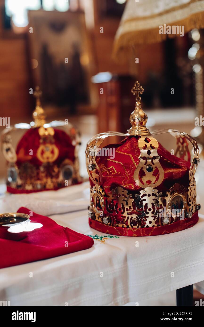 Two Beautiful Crowns With Gold And Red Cloth Stand On A Table In The Church Before The Baptism Of The Baby Stock Photo Alamy