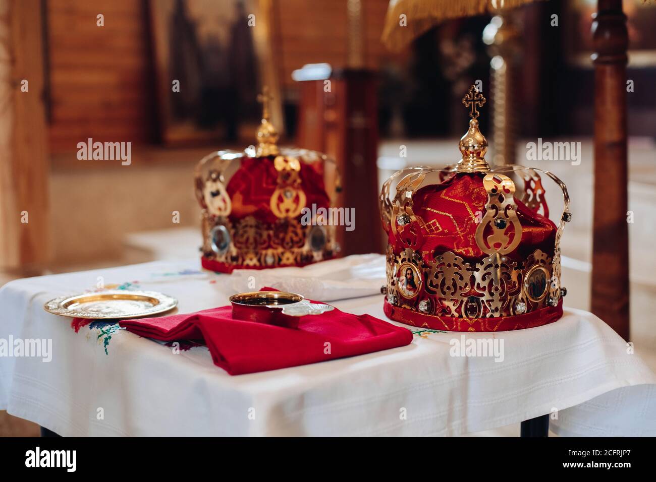 Two Beautiful Crowns With Gold And Red Cloth Stand On A Table In The Church Before The Baptism Of The Baby Stock Photo Alamy