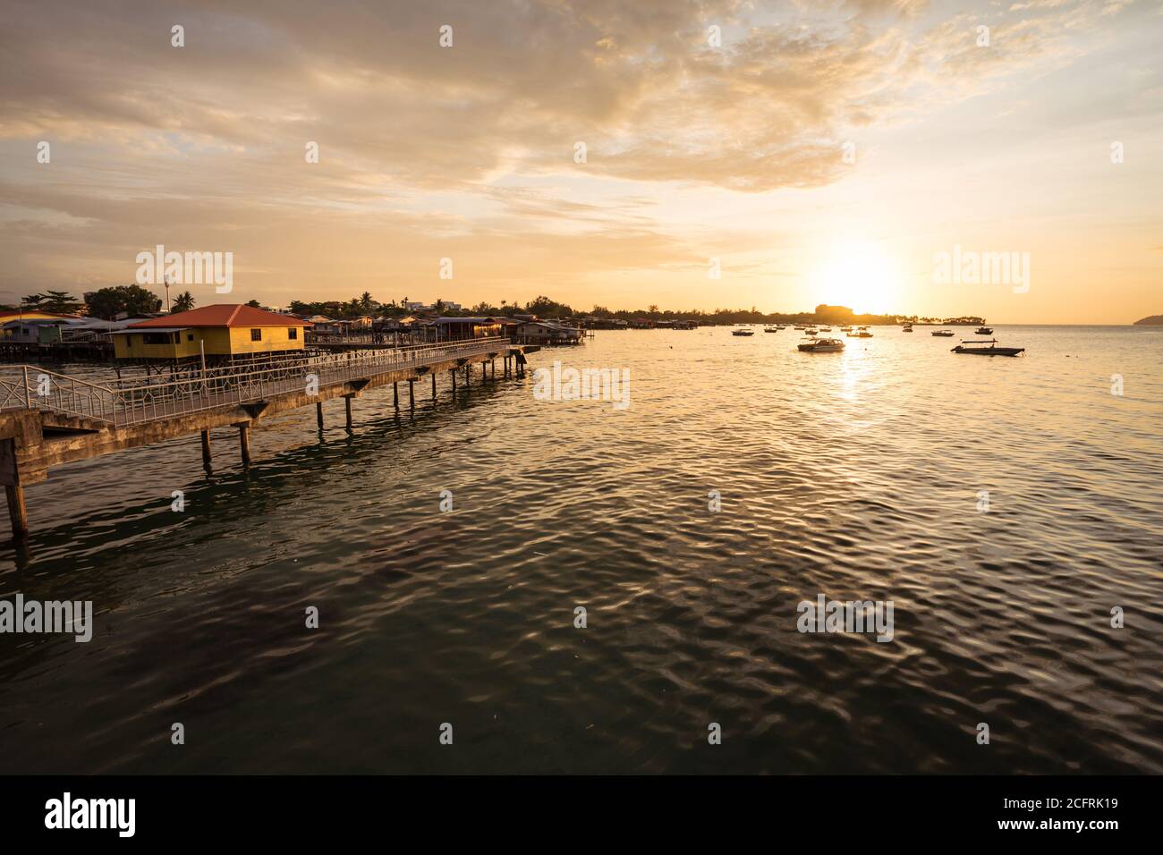 Kota Kinabalu / Malaysia - January 13, 2019: Beautiful sunset view over the sea next to Kampung Tanjung floating village in the coast of Sabah city Stock Photo