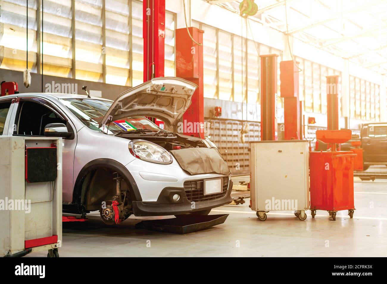 car repair station with soft-focus and over light in the background ...