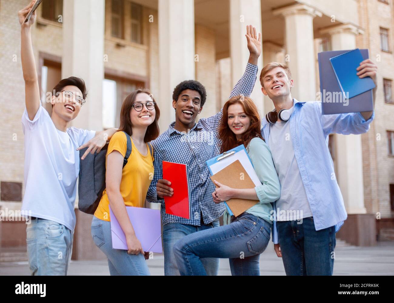 Happy First-Year Students Posing Standing Outside, Excited About Entering University Stock Photo