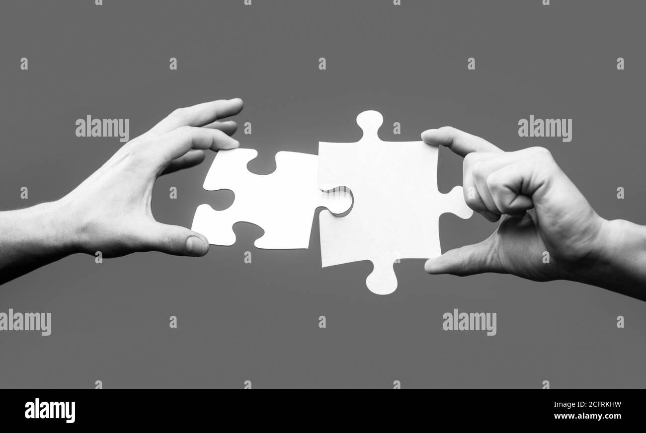 Closeup hands of man connecting jigsaw puzzle. Business solutions ...