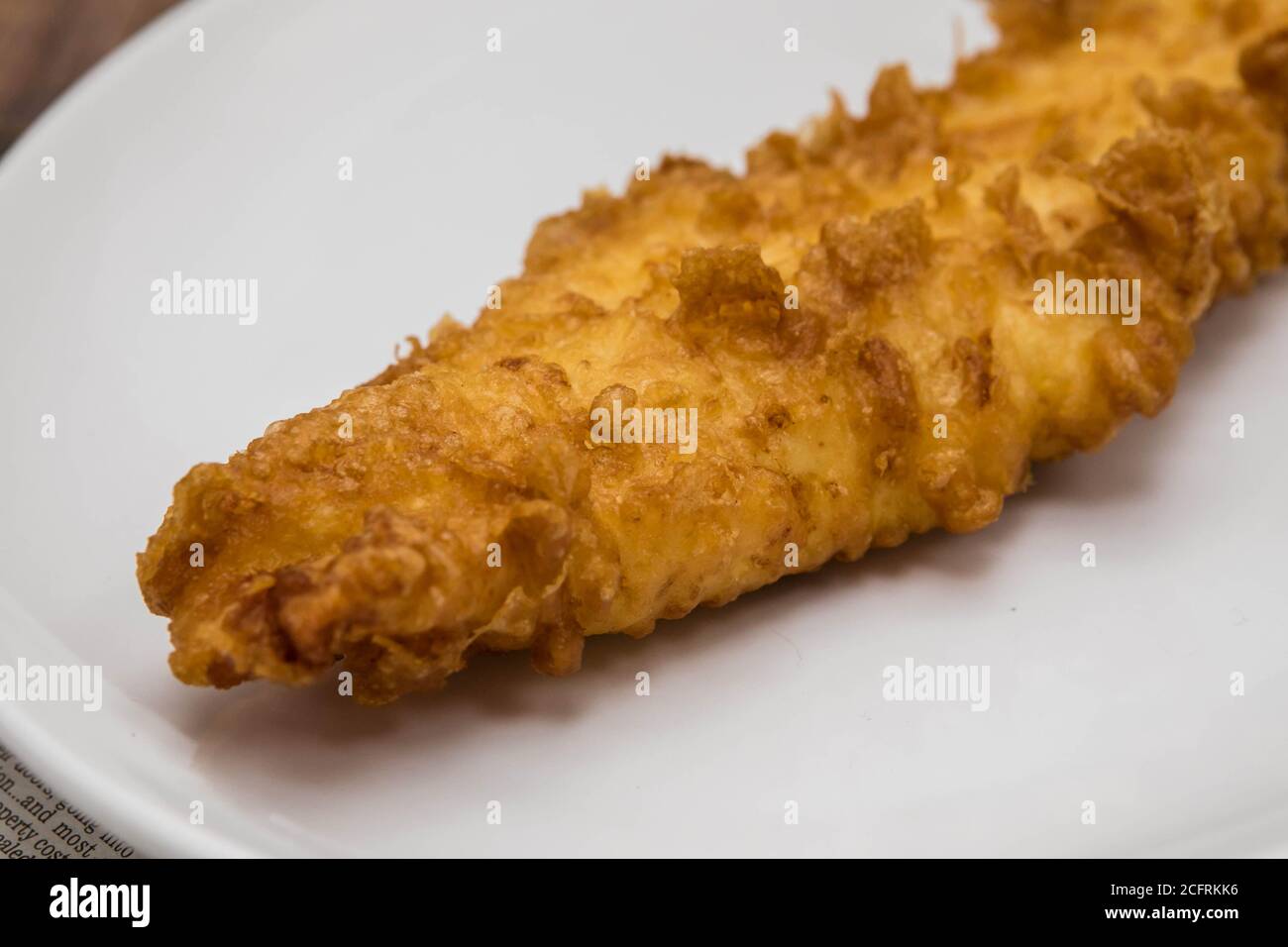 Battered fish - traditional British deep fried cod Stock Photo