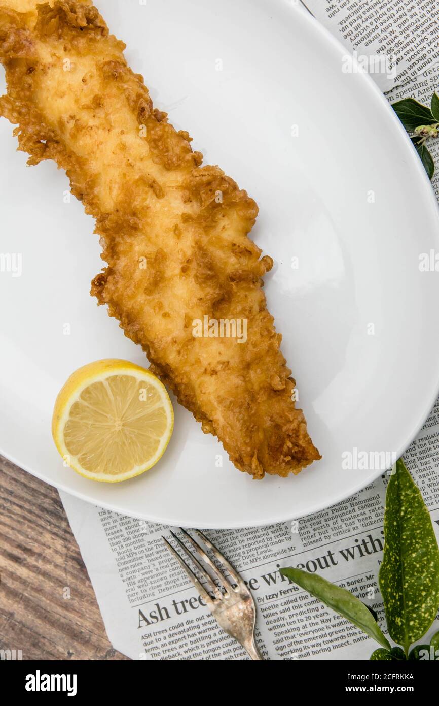 Battered fish - traditional British deep fried cod Stock Photo