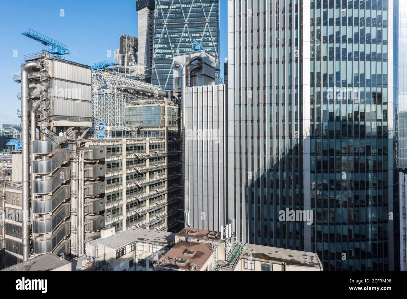 Elevated view of upper storeys with atrium, elevator towers and the Leadenhall building rises behind. Willis building on the right hand side. Lloyd's Stock Photo
