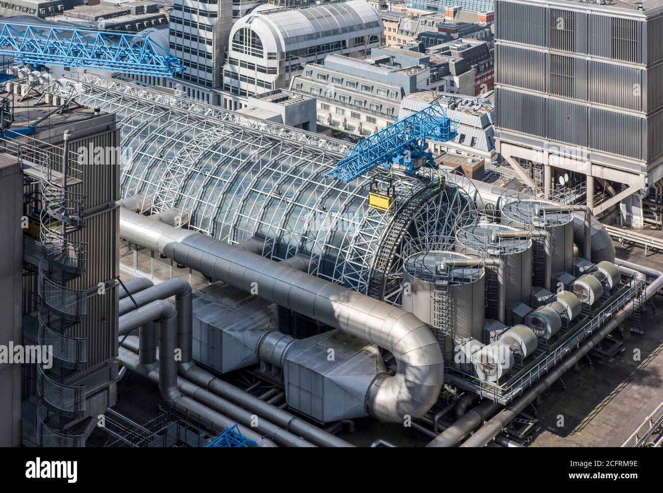The atrium of the building, seen from the Scalpel. Plant, elevator show blue cleaning cranes are clearly visible. Lloyd's Building, London, United Kin Stock Photo