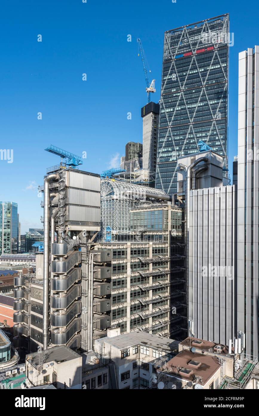 Elevated view of upper storeys with atrium, elevator towers and the Leadenhall building rises behind. Lloyd's Building, London, United Kingdom. Archit Stock Photo