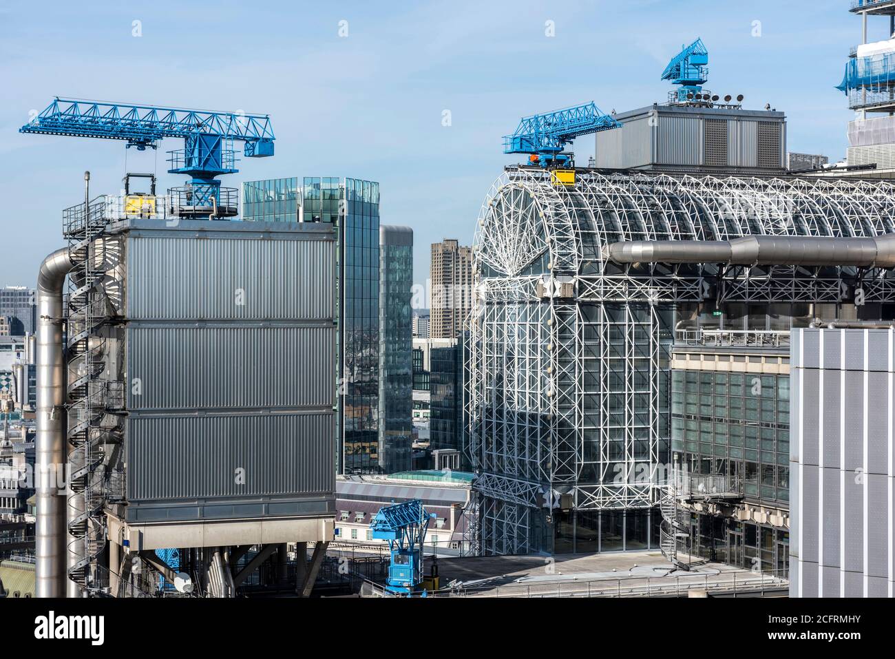 Elevator tower, atrium and blue cleaning cranes from the Scalpel. One of the Barbican towers can be seen in middle of frame. Lloyd's Building, London, Stock Photo