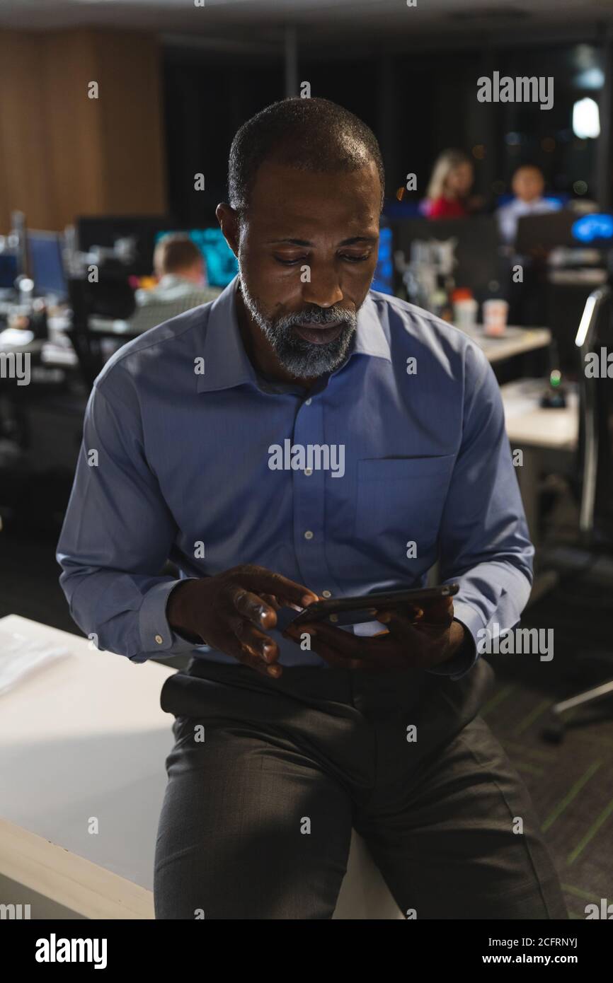 Senior businessman using digital tablet at modern office Stock Photo