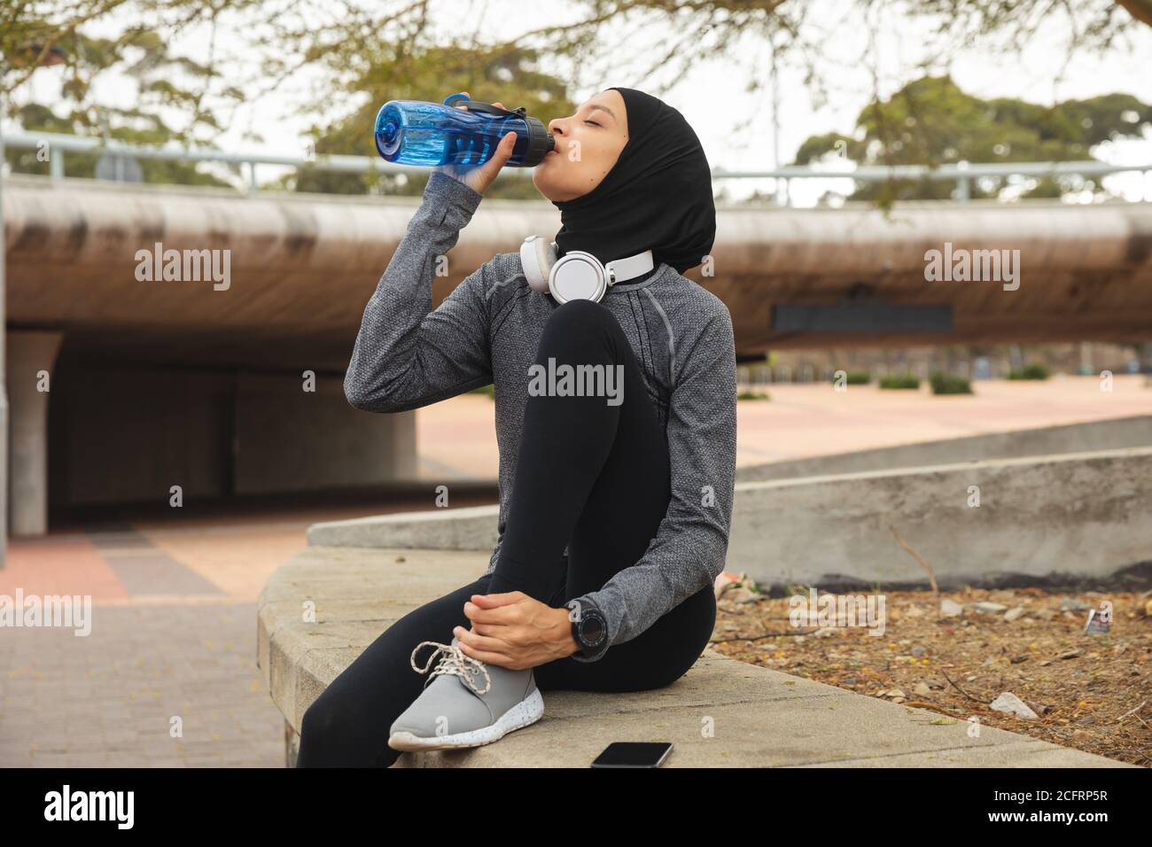Woman in hijab drinking water hi-res stock photography and images - Alamy