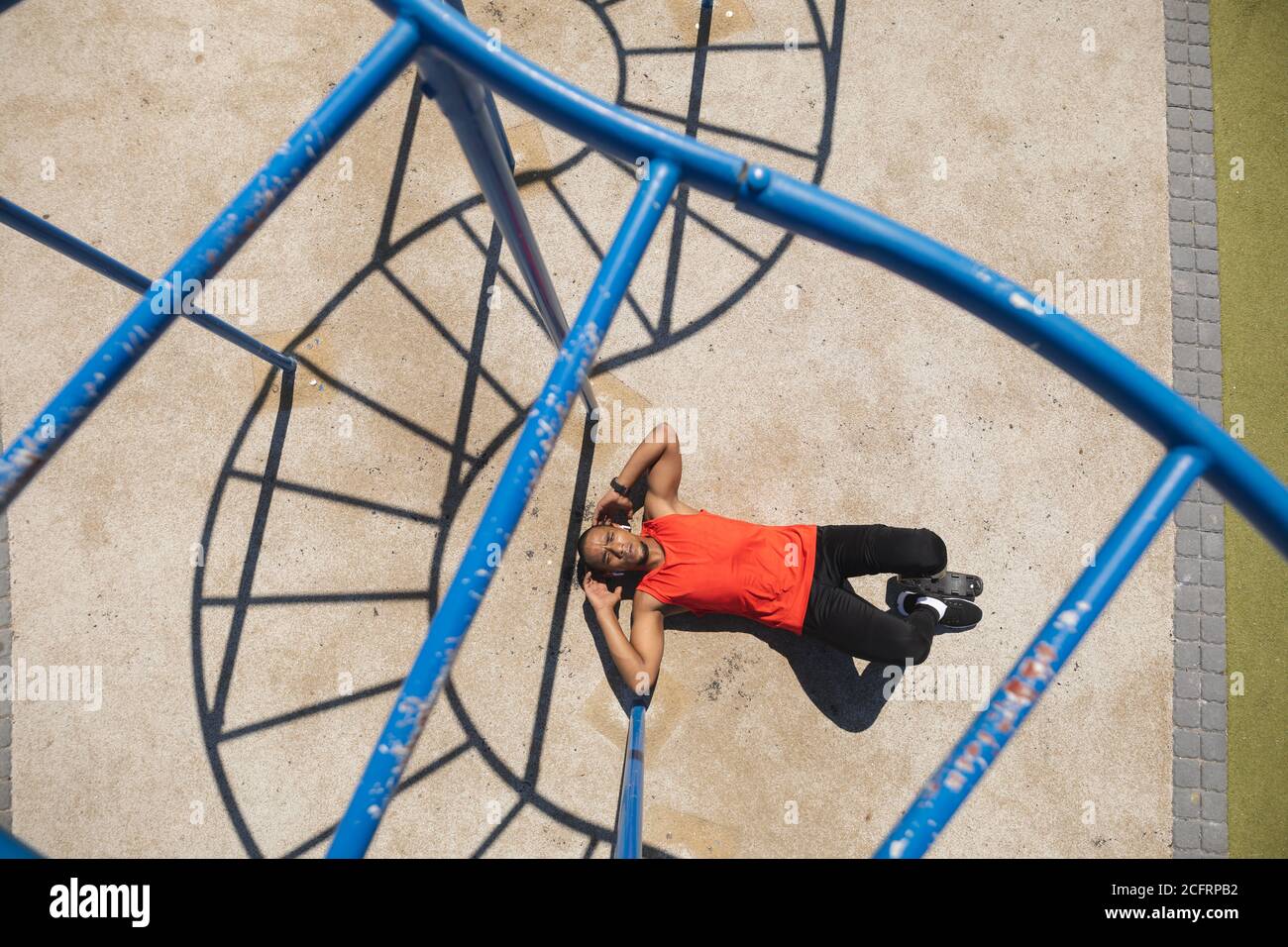 Man with prosthetic leg performing crunches exercise in the park Stock Photo
