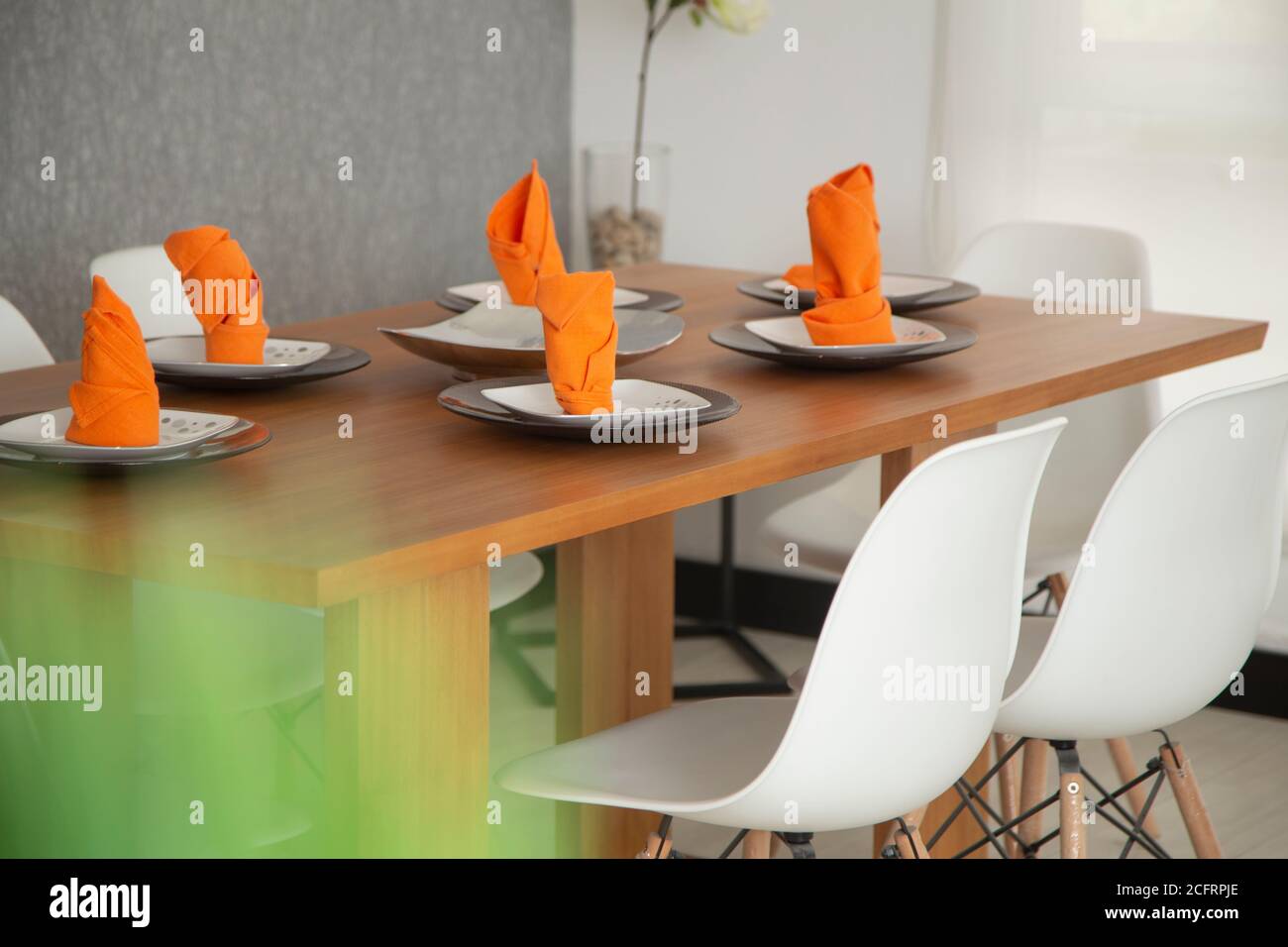 modern dining room with wood table and white chairs, close up of