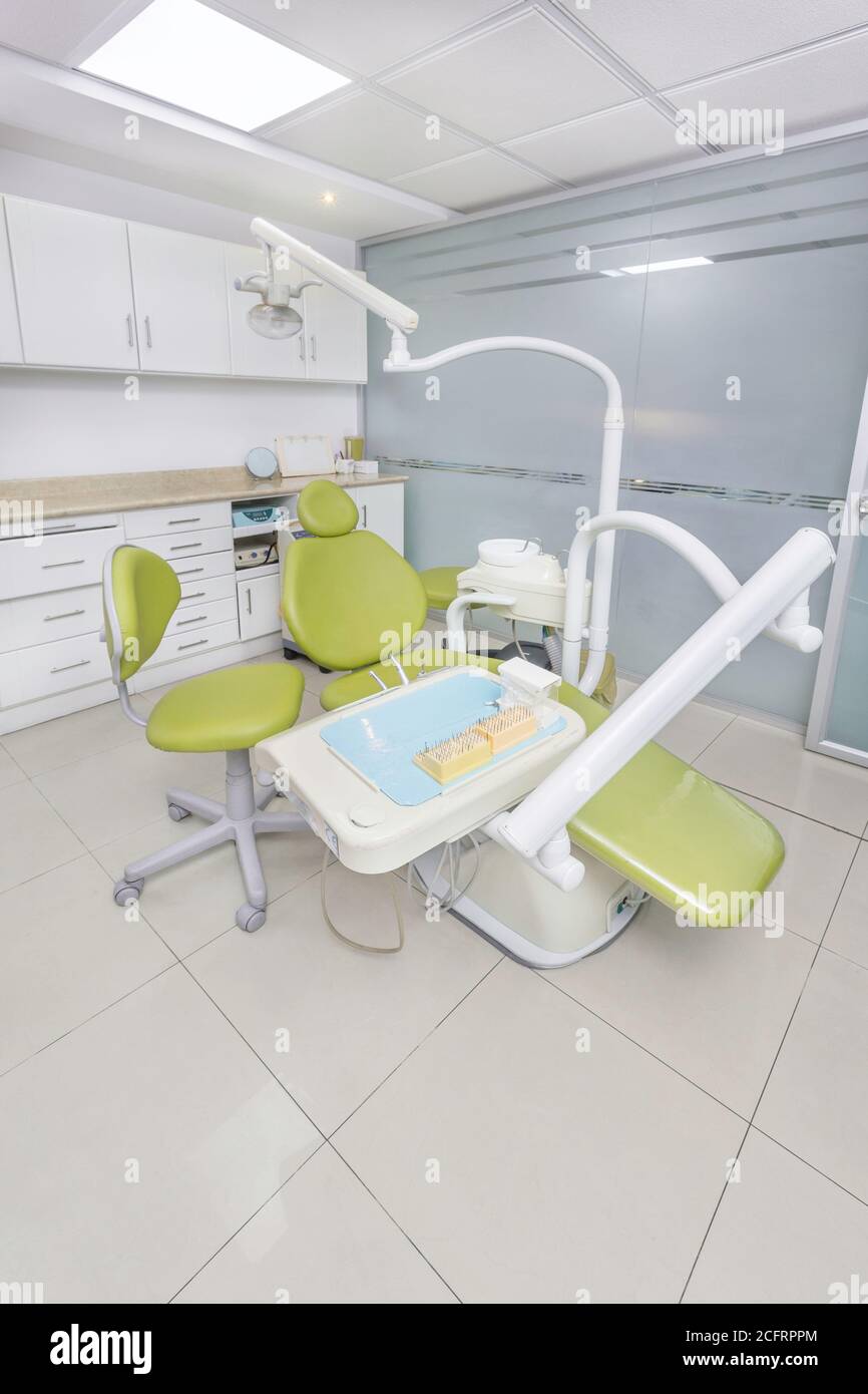 nice green dental office chair with medical instruments around, close up Stock Photo Alamy