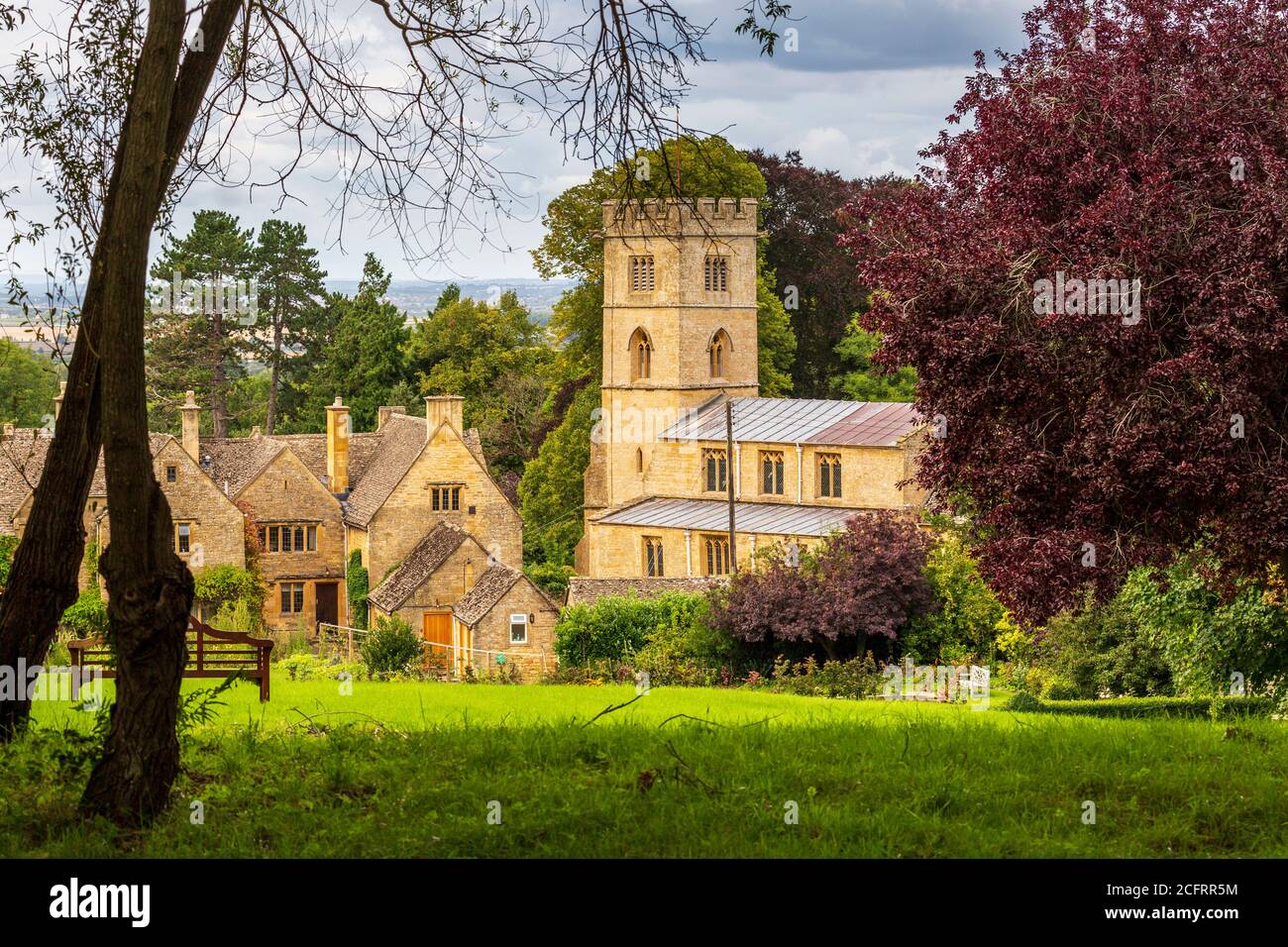 The church of St Michael in the Cotswold village of Buckland from the grounds of the Buckland Hotel, Gloucestershire, England Stock Photo