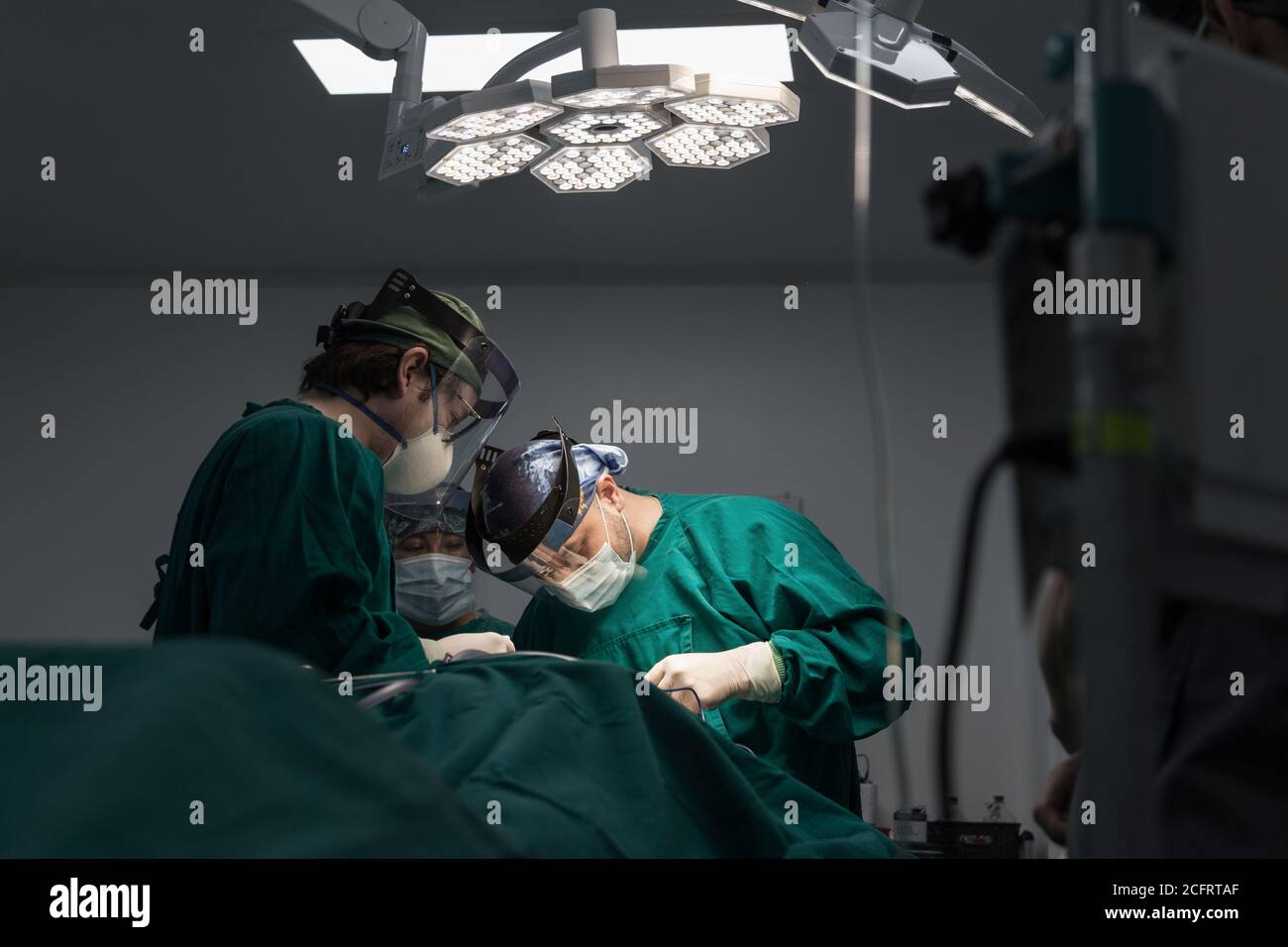 Surgeon in operation with instruments hi-res stock photography and ...