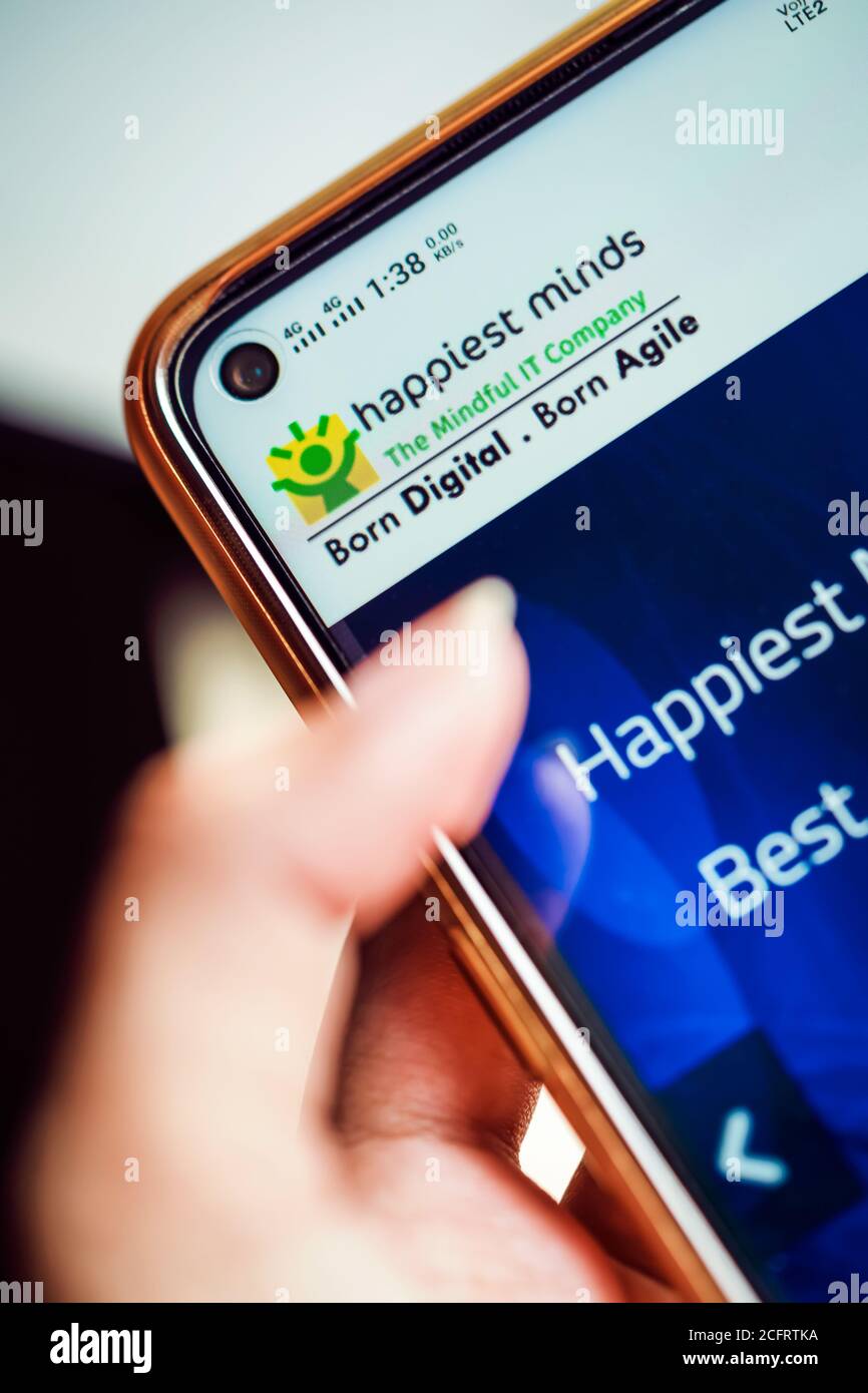 Kolkata, West Bengal, India, September 7, 2020 : Happiest Minds IPO background. Hand holding mobile phone and checking out Happiest Minds' official we Stock Photo