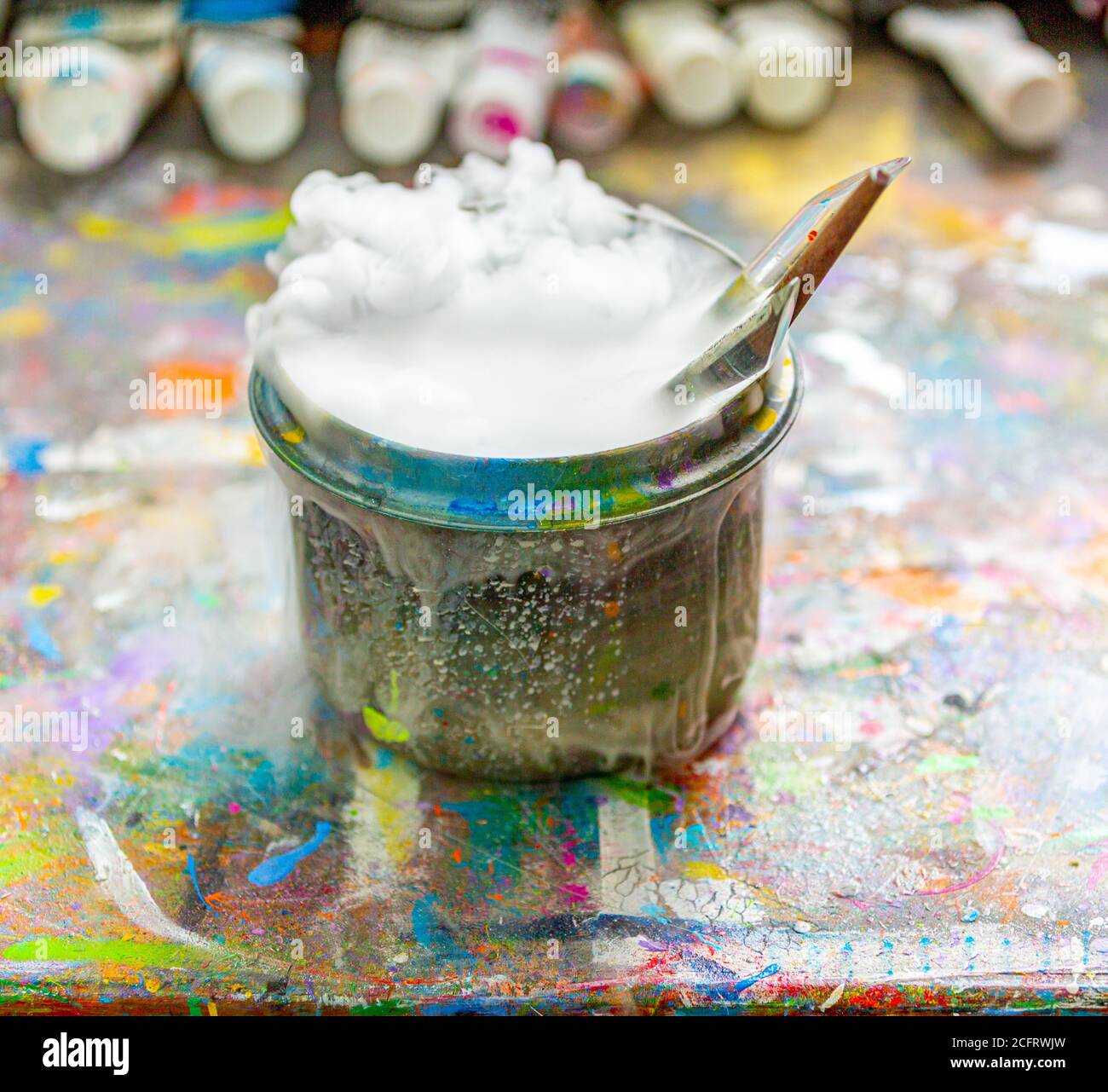 Artist's brushes in a bubbling container of water Stock Photo - Alamy