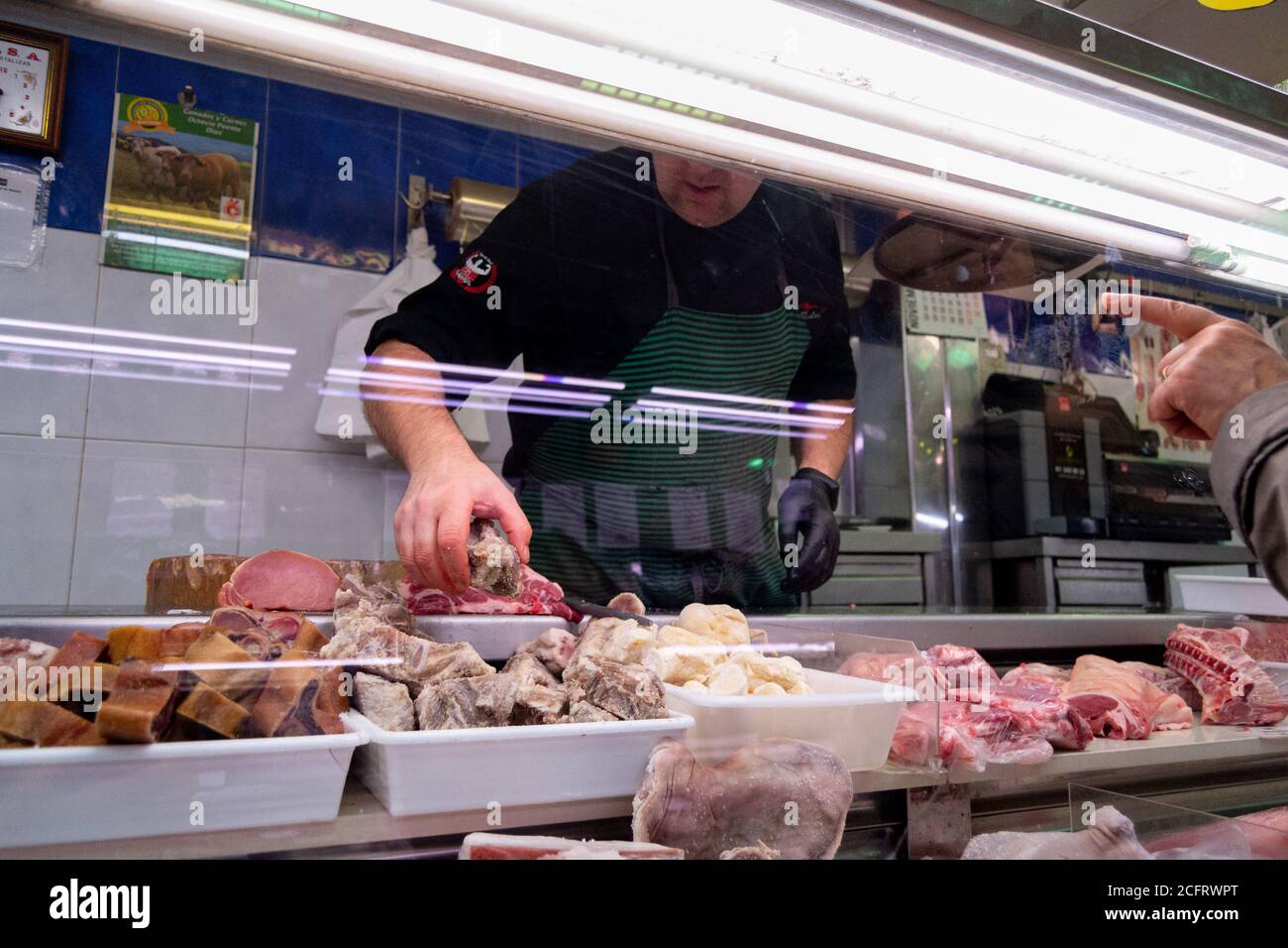 Butcher taking the meat that the customer told him to prepare and sell ...