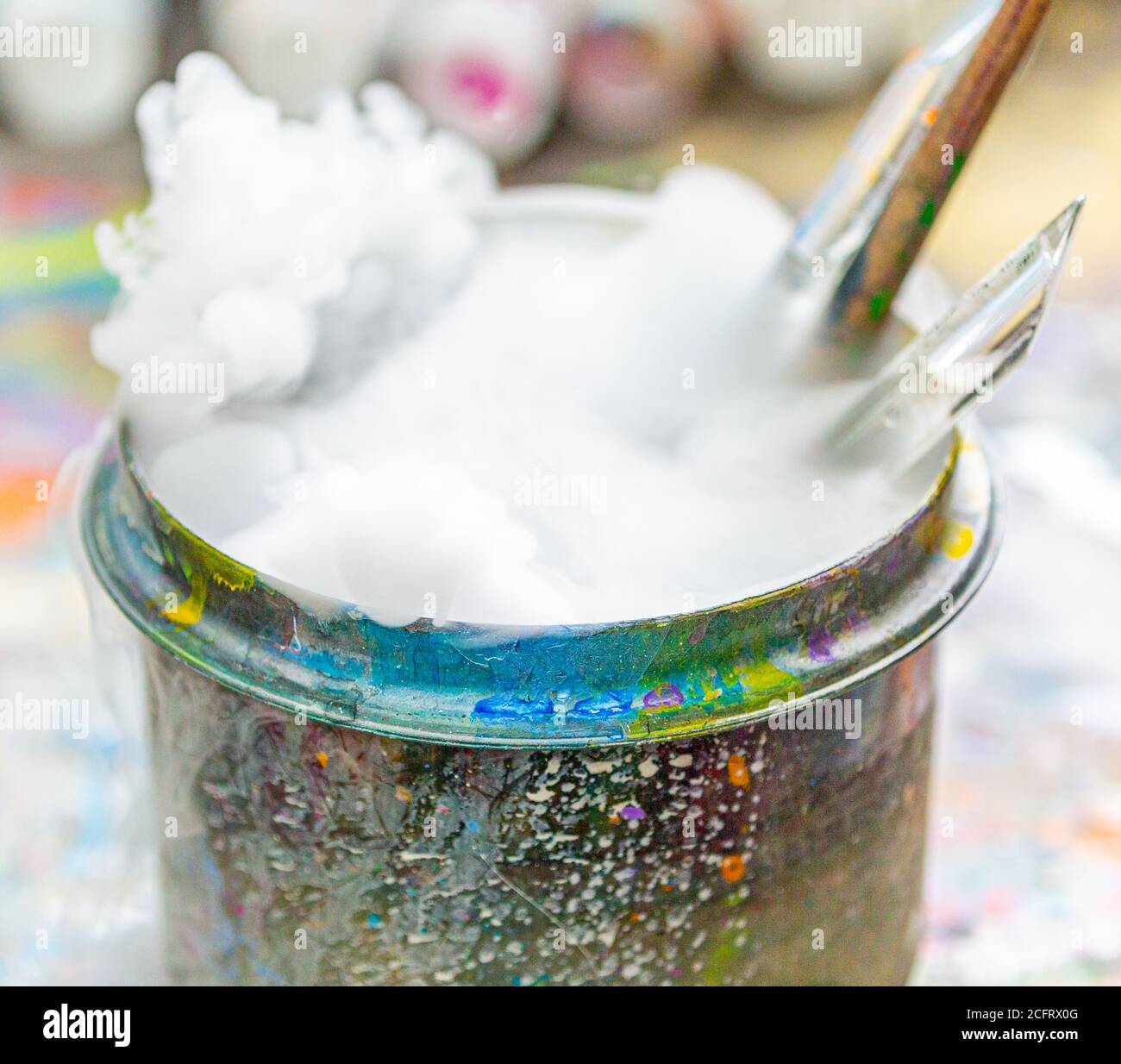 Artist's brushes in a bubbling container of water Stock Photo - Alamy