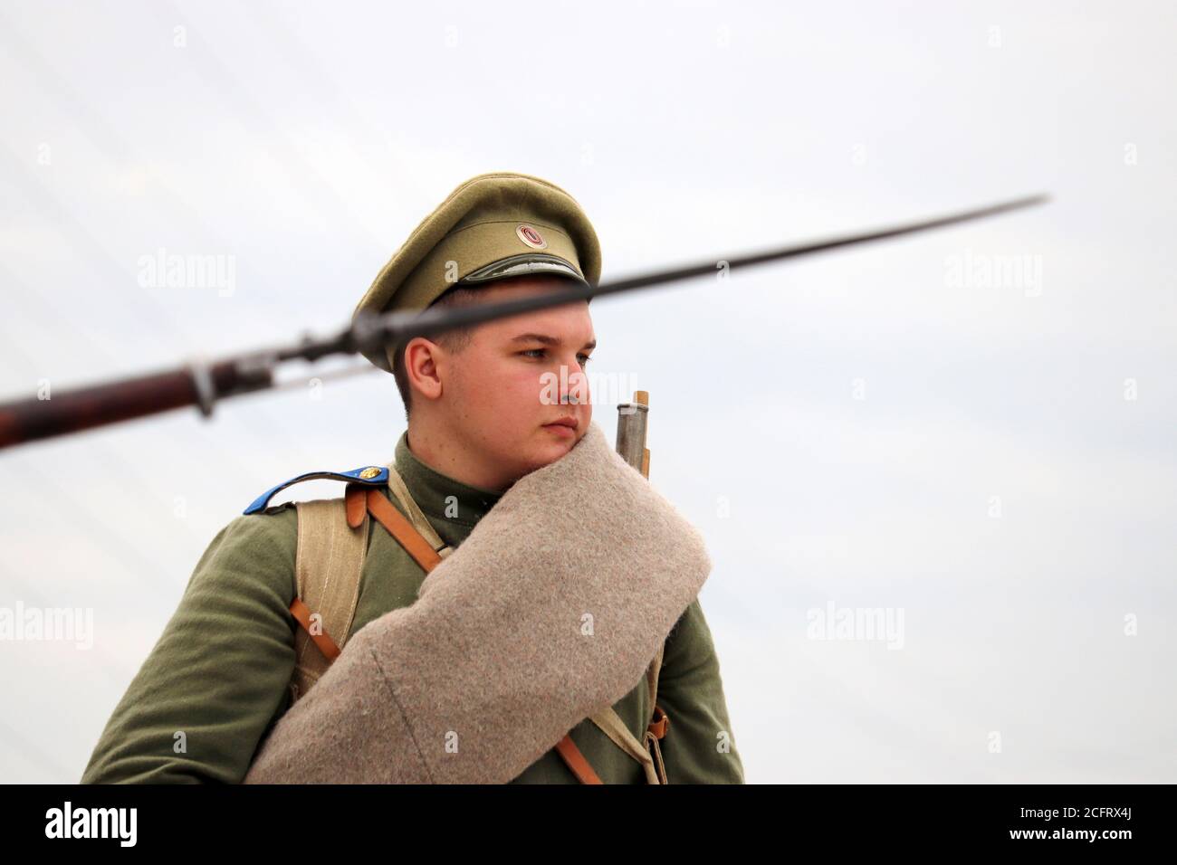 Soldier of the Russian Empire of early 20th century, view through the rifle with bayonet during the historical reconstruction of the World War I Stock Photo