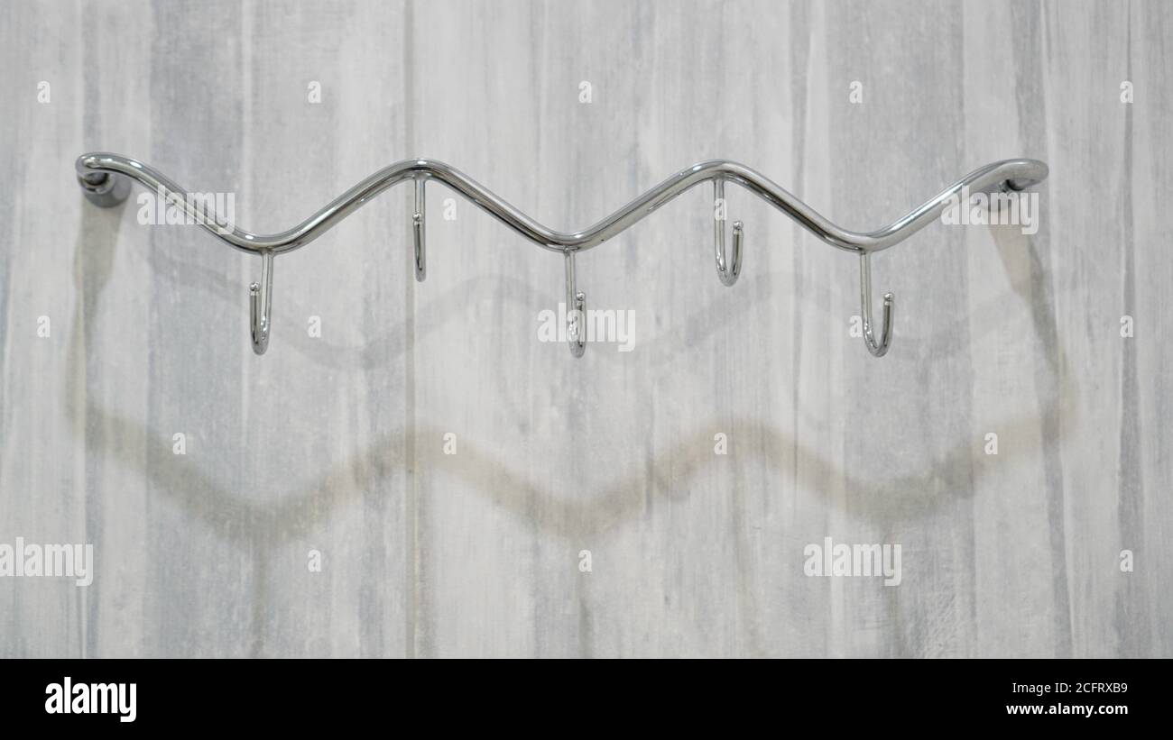 Big metal hooks for hanging stuff on a wall, isolated Stock Photo - Alamy