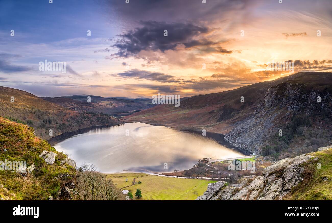 Dramatic sunset at Lake Lough Tay or The Guinness Lake in County Wicklow where Vikings village, Kattegat was located, Wicklow Mountains, Ireland Stock Photo