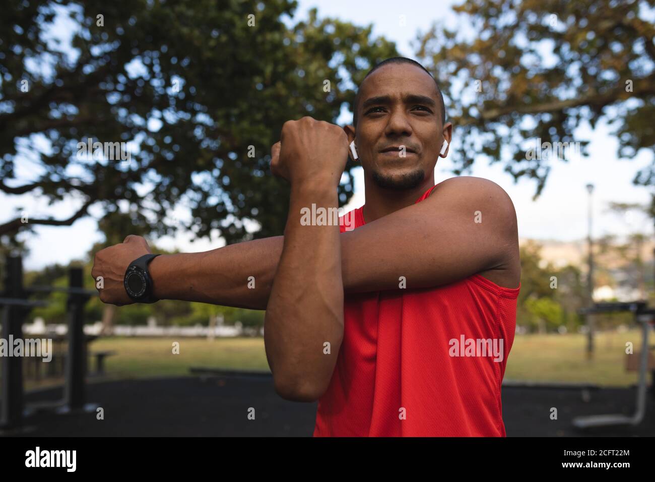Man performing stretching exercising in the park Stock Photo