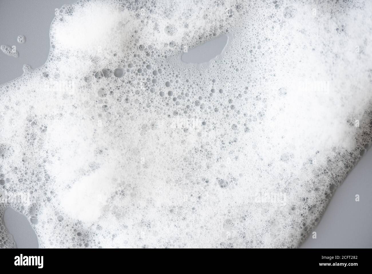 White foam on gray surface as texture Stock Photo