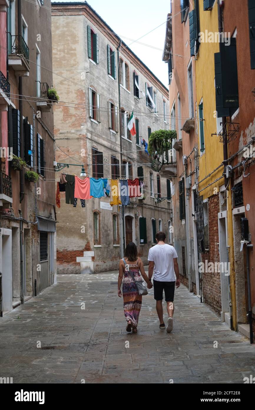 Atmosphere around 77th Venice International Film Festival  on Monday 7 September 2020 at Giardini della Biennale, Venice. A couple walk though the streets hand in hand. Picture by Julie Edwards. Stock Photo