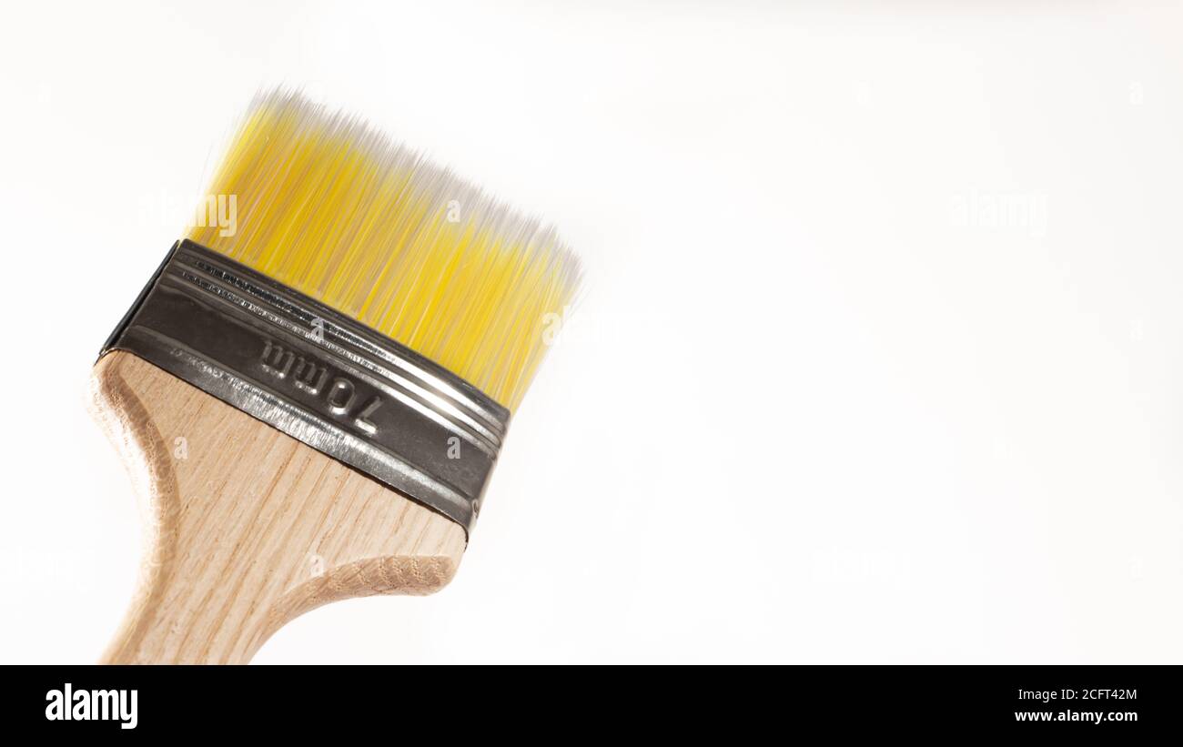 A paint brush on a white background with a place for text to paint walls and objects with paint