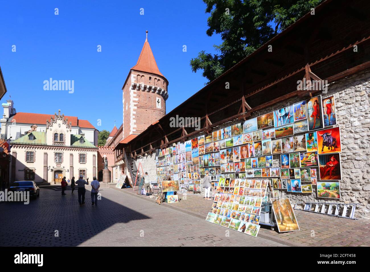 Cracow. Krakow. Poland.The part of medieval city walls. The open air art gallery selling paintings. The Carpenters Tower (Baszta Stolarzy) and Little Stock Photo