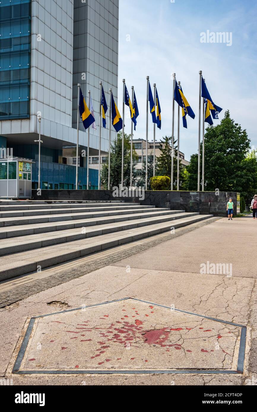 Sarajevo, Bosnia and Herzegovina - August 29, 2019: The Rose of Sarajevo is a marked place left by the bombing after the Balkan war. Sarajevo Rose is Stock Photo