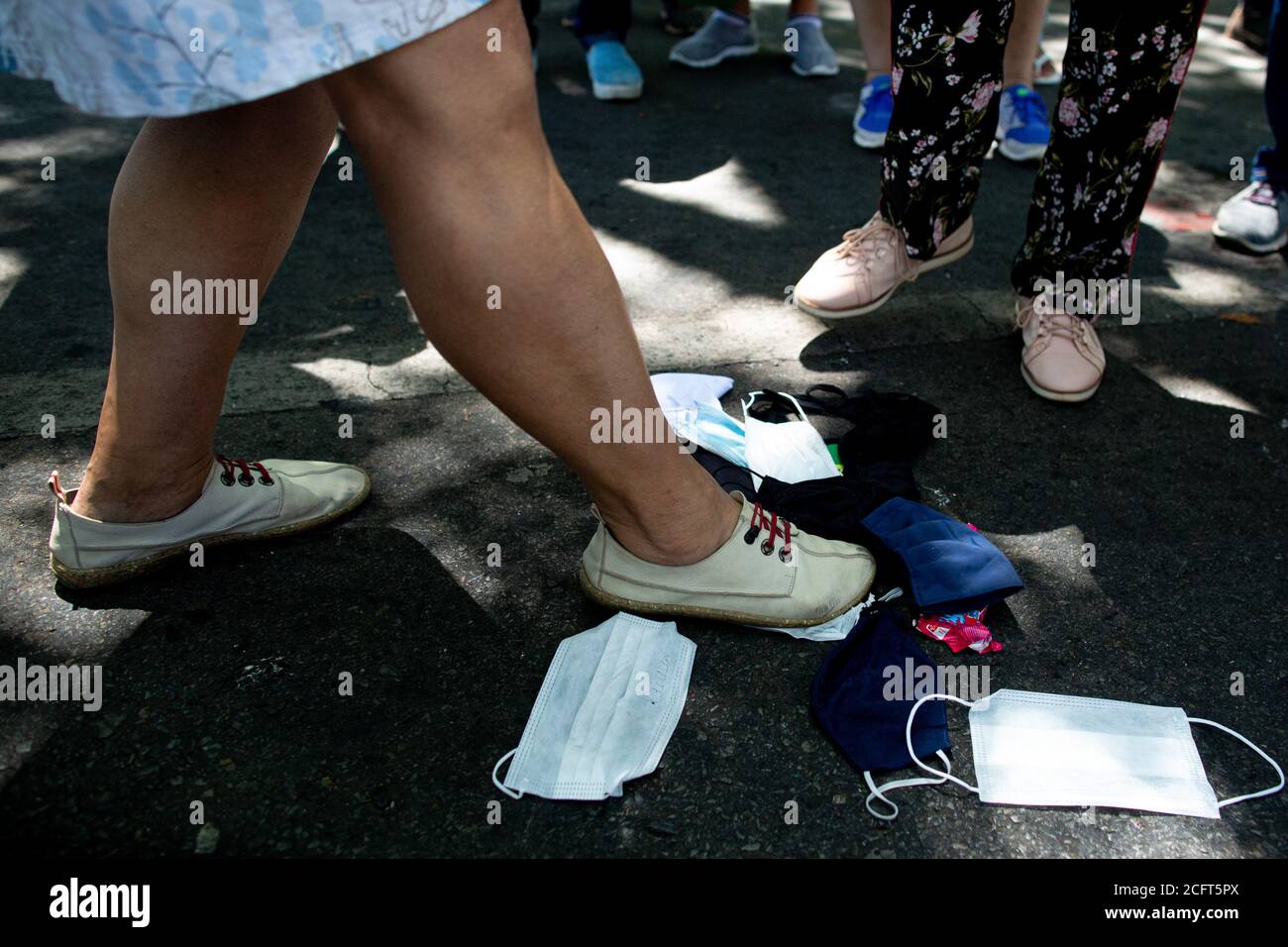 07 September 2020, Brazil, Brasilia: Supporters of President Bolsonaro  trample on face masks during celebrations of the Brazilian Independence  Day. In Brazil, more than 4 million people have been infected with Covid-19,