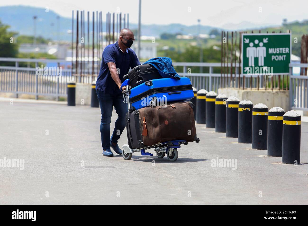 A passenger pushes his luggage at the Nnamdi Azikiwe international