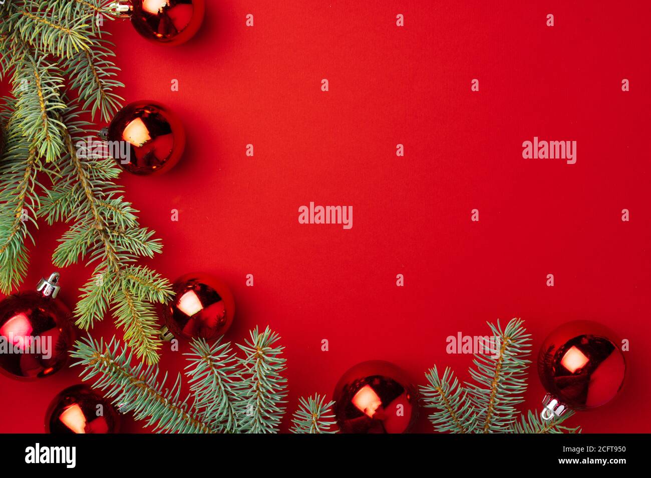 Christmas background with fir branches and balls on red Stock Photo - Alamy