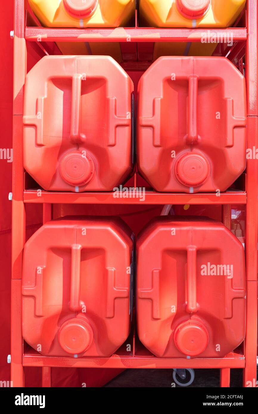 Big Red Plastic Canisters at Storage Rack Stock Photo - Alamy