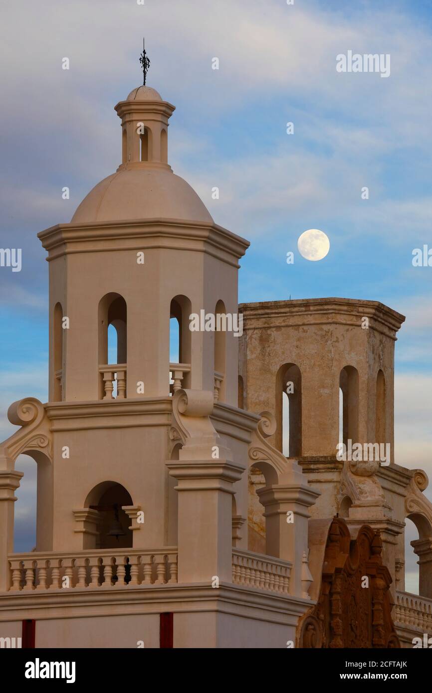 Tohono O'odham Indian Reservation  AZ / DEC Dusk moonrise over the Kino mission of San Xavier del bac. V1 Stock Photo