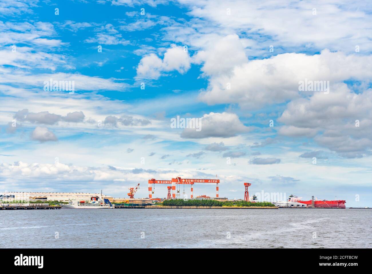 yokosuka, japan - july 19 2020: Tower cranes of the dry docks of the Yokosuka Shipyard Sumitomo Heavy Industries Marine & Engineering. Stock Photo