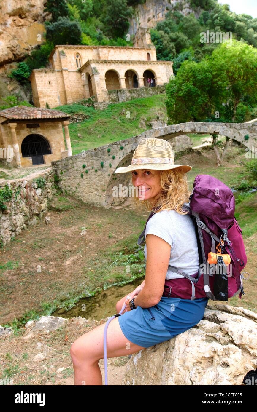 Hiker mature young woman close to an old chapel Stock Photo - Alamy
