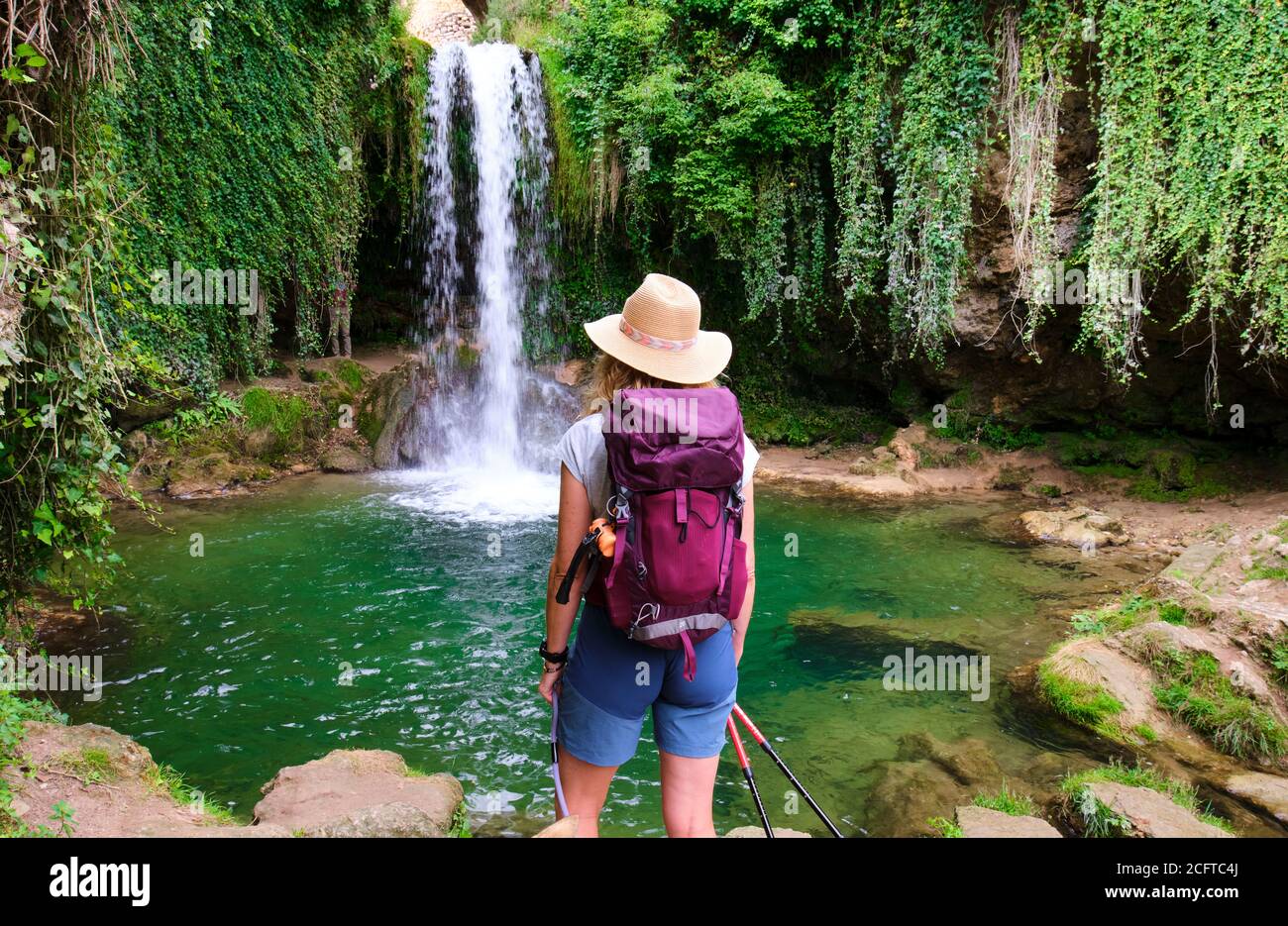Hiker mature young woman and waterfall Stock Photo - Alamy