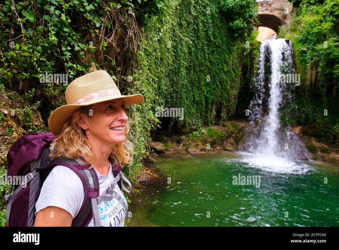 Hiker mature young woman and waterfall. Stock Photo