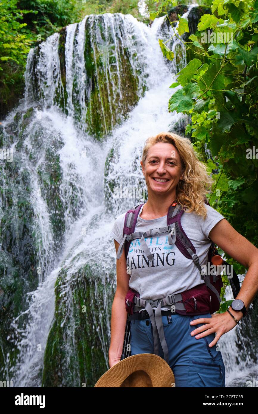 Hiker mature young woman and waterfall Stock Photo - Alamy
