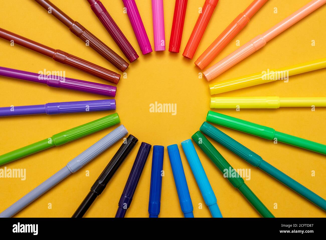 Colored markers on orange background Stock Photo